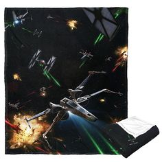 the star wars blanket is on display in front of a black background with green and red lights