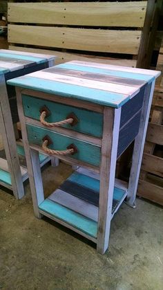 two wooden side tables with rope handles and drawers on each end, one painted blue and the other white