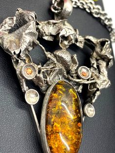 "UNIQUE AMBER PENDANT Hand-made Sterling Silver. Stones used: Amber, Garnet, Citrine. Height - 80mm, Width - 56mm. Unique Handcrafted One-of a-kind Design Pendant Each Piece of Jewelry in my Collection is Absolutely One of a Kind! When you start wearing a piece of my jewelry you will fall in love with it more and more each day and feel that good Energy and Love that I pass into it while creating this piece of Art. A piece of Art created for you to be inspired and love it through all your life. I Artistic Hallmarked Jewelry For Formal Occasions, Antique Amber Sterling Silver Jewelry, Amber Antique Sterling Silver Jewelry, Artistic Silver Necklaces With Polished Finish, Antique Amber-colored Sterling Silver Jewelry, Amber Sterling Silver Necklaces With Cabochon, Amber Cabochon Necklaces In Sterling Silver, Amber Cabochon Necklace In Sterling Silver, Amber Sterling Silver Necklace With Cabochon