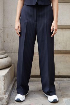 Level up your wardrobe essentials with these wide-leg pinstripe trousers from Threadbare. The wide hem and pintuck waist of these wide-leg trousers creates a leg-lengthening silhouette and elegant finish. Zip and fly fastening, with two hooks on the internal waistband, these pinstripe trousers have belt loops on the waistband for you to add your own accessories and cinch the waist as you wish. Pair with a white top and trainers for a casual everyday look, or a shirt and low-block heels for a chic work outfit. Model Wears UK Size 8. Chic Work Outfit, Pinstripe Trousers, Going Out Trousers, Work Wear Outfits, Soft Tailoring, Formal Trousers, Tshirt Skirt, Tailored Trousers, Shirt Skirt