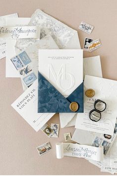 an assortment of wedding stationery items including envelopes, rings, and other things