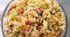 a bowl filled with pasta salad on top of a table