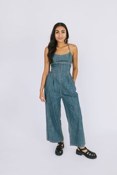 Update your wardrobe with this stylish and fun When In Doubt Jumpsuit! Featuring a wide-leg fit, adjustable tie straps, and pockets, this jumpsuit is perfect for any activity—from a day at the park to a night out on the town! Details Wide leg Adjustable tie straps Pockets! Back zipper closure Sizing Approximate measurements: SIZE LENGTH* BUST INSEAM Small 49” 28” 25.5” Medium 51” 30” 26” Large 52” 32” 26” *Length does not include straps Fabric has no stretch Model is 5’5” wearing small Material Cheap Non-stretch Cotton Denim Jumpsuit, Non-stretch High Rise Denim Jumpsuit With Pockets, Non-stretch Denim Jumpsuit With Pockets, High Rise Non-stretch Denim Jumpsuit With Pockets, Cotton Denim Jumpsuit With Button Closure, Straight Leg, Victorian Purses, Chambray Jumpsuit, Comfortable Jeans, Light Denim