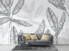 a living room with a couch and wall mural