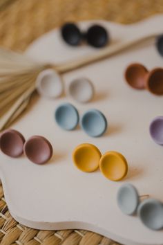 several different colored bowls sitting on top of a white tray next to bamboo straws