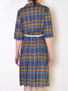 Cool vintage dress made of thinner fabric - navy blue with print of white grid and dots with yellow zig-zags. Collared. Half sleeves gathered on the shoulders. Flared, pleated midi-length skirt part. Belt loops. Belt not included. Era: 70's or, most likely unique, tailored piece Fabric: polyester Condition: very good Estimated size: L / XL (please, check the measurements) Measurements (measured flat, need to be doubled to get the circumference): Chest: 51cm / 20 inches Waist: 45 cm / 17,7 inches Retro Summer Midi Dress For Work, Retro Short Sleeve Patterned Dress, Retro Patterned Dress With Short Sleeves, Retro Patterned Short Sleeve Dress, Summer Workwear Dresses With Geometric Pattern, Retro Navy Dress For Spring, Retro Geometric Pattern Dress For Spring, Retro Dresses With Geometric Pattern For Spring, Retro Spring Dress With Geometric Pattern