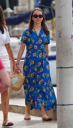 two women walking down the street holding hands