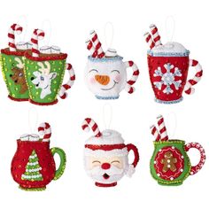 four christmas mugs are hanging from strings on a white background with snowman, reindeer, and santa clause