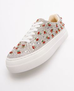 Put a little sparkle in your step with the SIDNY all-over rhinestone platform sneakers. These sparkly cherry embellished sneakers can be paired with your best dress or favorite jeans, offering a combination of glamour and stylish comfort. The SIDNY rhinestone shoe is available in a variety of captivating colors and prints to make any look a little more luxurious! Manmade upper materials with rhinestones and charms Lace-up closure Textile lining with cushioned insole Textured rubber outsole 1.5" inch platform 45.27” inch total shoe-lace length Recommended to clean with a dry cloth Imported Embellished Sneakers, Best Dress, Rhinestone Shoes, Shoe Lace, Spring Trends, Platform Sneakers, Shoe Box, Favorite Jeans, Women's Sneakers