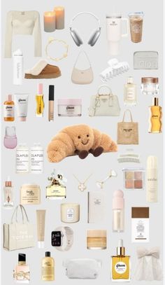 the contents of a woman's purse are arranged on a white background, including perfumes and other items