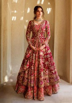 Royal Pishwas Frock Lehenga Pakistani Bridal Dress is a magnificent masterpiece that gives the gorgeous bride her desired dreamy appearance at the wedding. Resham, dabka, gota, Kiran, and sequins make this Pishwas Dress your priority for the big day. Pishwas: The Pishwas Frock has the perfect contrast of glamorous red and pink colors. The Pishwas come in layered style and is hand-embellished with fine details of Resham, sequins, cut-dana, Kiran, Gota, and Naqshi work. Intricate designs and beami Anarkali For Bride, Red Bridal Anarkali Suits, Anarkali Bridal Dress, Anarkali Suits For Engagement, Anarkali Dress For Engagement, Anarkali Bridal Suits, Desi Bridal Outfits, Frocksuit Design For Women, Wedding Anarkali Dress Indian Bridal