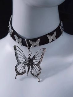 Add a touch of whimsy and elegance to your accessory collection with this stunning choker. Crafted from high-quality faux leather, this choker is both durable and comfortable to wear. The centerpiece features a delicate metal butterfly pendant. Surrounding the choker are additional butterfly decorations, creating a cohesive and enchanting look. The adjustable design ensures a perfect fit for any neck size. Gothic Adjustable Choker For Concerts, Adjustable Gothic Choker With Chain, Gothic Metal Choker Necklace, Adjustable Black Gothic Choker, Adjustable Heart-shaped Punk Choker, Steampunk Fashion Male, Tie Necklace, Steampunk Accessories, Black Choker