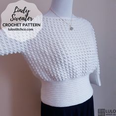 a white knitted sweater on a mannequin