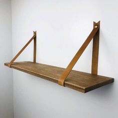 a wooden shelf hanging on the wall