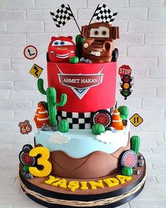 a three tiered cake with cars on it