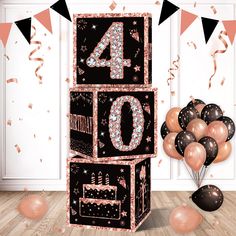 a birthday cake with candles and balloons in front of the number forty sign that reads 40