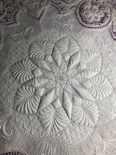 a quilted table cloth with an intricate design on it