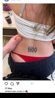 the back of a woman's stomach with numbers tattooed on her lower body and chest