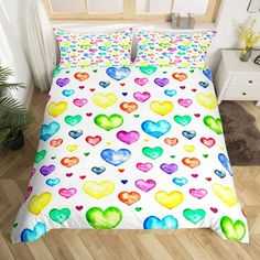 a bed with colorful hearts on it in a room