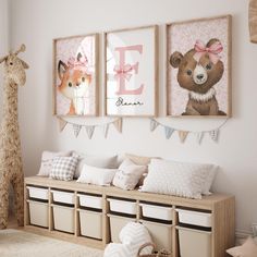 a child's room with three pictures on the wall and two stuffed animals hanging above