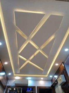 the ceiling is decorated with white lights and wood paneling, along with other decorations