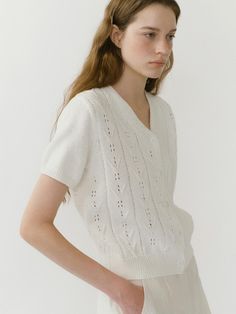 This lightweight knit cardigan features feminine V-neckline and short sleeved design. It is accentuated with unique, flower-patterned punching detail throughout. - Natural, standard fit- Cotton knit fabric- Ribbed finishes at cuffs and hem- Both casual and feminine feel- Versatile styling and easy layering Feminine Knit V-neck Cardigan, Feminine V-neck Pointelle Knit Sweater, Classic V-neck Knit Top For Summer, V-neck Pointelle Knit Cardigan, Classic V-neck Spring Knit Top, Classic White V-neck Knit Top, White Fine Knit V-neck Top, Feminine Pointelle Knit V-neck Sweater, Spring Textured Knit Short Sleeve Sweater