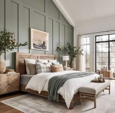 a bedroom with green walls and white bedding