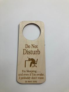 a wooden door hanger that says do not disturb i'm sleeping and even if i'm awake, i probably don't want to see you