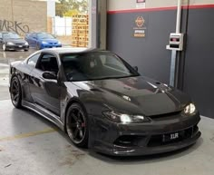 a black sports car parked in a garage