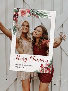 two beautiful women standing next to each other in front of a white fence holding up a christmas card