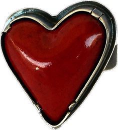 a red heart shaped metal object on a white background