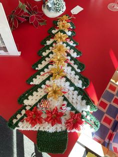 a crocheted christmas tree sitting on top of a table