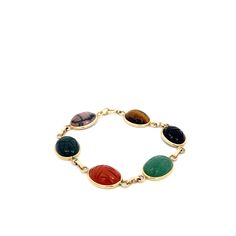 Vintage Multi Gem Scarab Bracelet in 14k Yellow Gold. This Unique and Uber Cool Link Bracelet is Sure to be the Star of Any Wrist Stack. Carved on Both Sides of the Stones, Add a Pop of Color and Texture to Your Jewelry Collection. Onyx, Tigers Eye, Aventurine, Carnelian, Bloodstone, Rhodonite. Measuring Approximately 16mm x 12mm Each.  7.375 Inch Length Stamped and Authenticated 14k Yellow Gold 15.3 Grams Wrist Stack, Scarab Bracelet, Wrist Stacks, Tigers Eye, Lovely Things, Chain Link Bracelet, Link Bracelets, Tigers, Chain Link