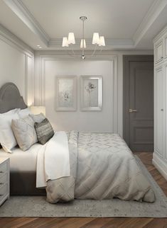 a large white bed sitting in a bedroom on top of a hard wood floored floor