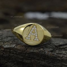 This ring is made with Genuine 0.10 Ct. SI Clarity G-H Color Diamond 'A' Initial Signet Ring Solid 14k Yellow Gold Personalized Party Wear Jewelry/ Bridesmaid Gift. * SKU: SR01012 * Made to Order. * Gold Purity: 14K Solid Yellow Gold (stamped) * Custom Gold Color: Yellow, Rose, White Gold * Custom Gold Purity: 9K/14K/18K (Charges Apply) * Diamond 100% Genuine Diamond * Diamond Weight: 0.10 ct. * Diamond Color: G-H * Diamond Clarity: SI1- SI2 * Diamond Cut: Brilliant Cut (Excellent) Product Measu Personalized Yellow Gold Diamond Ring In Sterling Silver, Personalized Diamond Initial Ring For Anniversary, Anniversary Fine Jewelry Initial Ring With Round Cut, Anniversary White Gold Diamond Initial Ring, Personalized Yellow Gold Cubic Zirconia Rings, Personalized Yellow Gold Rings With Cubic Zirconia, Vvs Clarity Diamond Initial Ring Round Cut, Vvs Clarity Round Cut Diamond Initial Ring, Anniversary Cubic Zirconia Signet Ring Stamped 14k