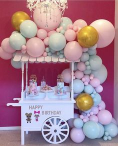 an ice cream cart decorated with balloons and confetti for a birthday party or baby shower