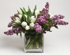 a vase filled with white and purple flowers