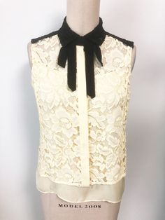 This is a two piece set from Sandro, Paris.  The tank is a soft yellow in the front and black in the back.  It has adjustable straps.  The lace blouse buttons down the front and has a grosgrain ribbon at the neckline.  It is also yellow in front and black in back.  Lots of mix and match options.  Size tag 3.  Check measurements carefully, no stretch.  Small red marker dot on label, no other flaws noted. Measurements taken with tops laying flat and doubled where appropriate. In order to determine Sandro Paris, Soft Yellow, Yellow Top, Black And Yellow, Blouse Length, Two Piece Set, Lace Blouse, We Wear, Grosgrain Ribbon