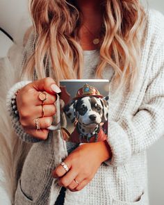 a woman holding a coffee mug with a dog on it