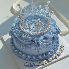 a blue cake with a tiara on top