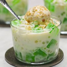 a dessert in a glass dish topped with ice cream and green leafy garnish