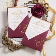 the wedding stationery is laid out in front of a mirror with a rose on it