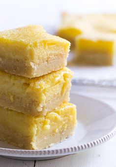 three pieces of yellow cake sitting on top of a white plate