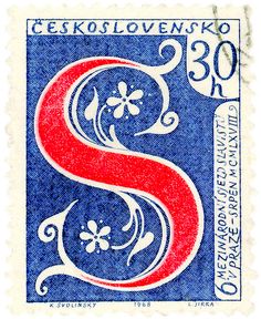 a stamp with the letter s in red, white and blue on it's side