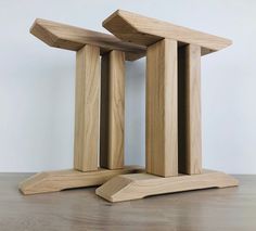 two wooden sculptures sitting on top of a table