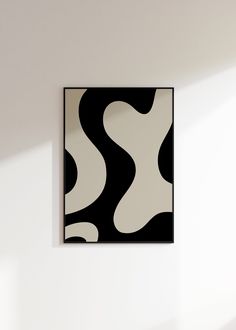 a black and white painting hanging on the wall