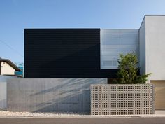 a black and white house on the corner of a street