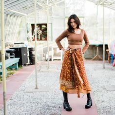 Model is wearing an orange tea length sari wrap skirt while standing in a greenhouse. Sari Wrap Skirt, Double Layer Skirt, Silk Wrap Skirt, Tea Length Skirt, Skirt Silk, Layer Skirt, Wrap Skirts, Wrap Around Skirt, Simple Outfit