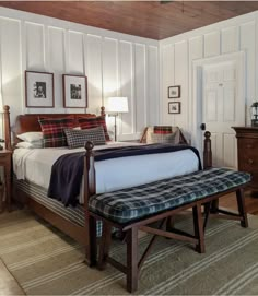 a bed sitting in a bedroom next to a wooden dresser and lamp on top of a rug