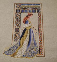 a cross stitch picture of a woman in a blue and white dress